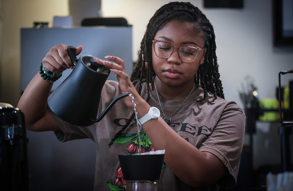 Barista at the pourover bar, kettle in hand